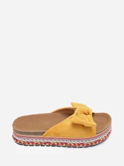 New La Modeuse Mules  à noeud et semelle à motifs Jaune