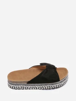 New La Modeuse Mules  à noeud et semelle à motifs Noir