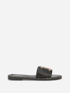New La Modeuse Mules plates à détails dorés Noir